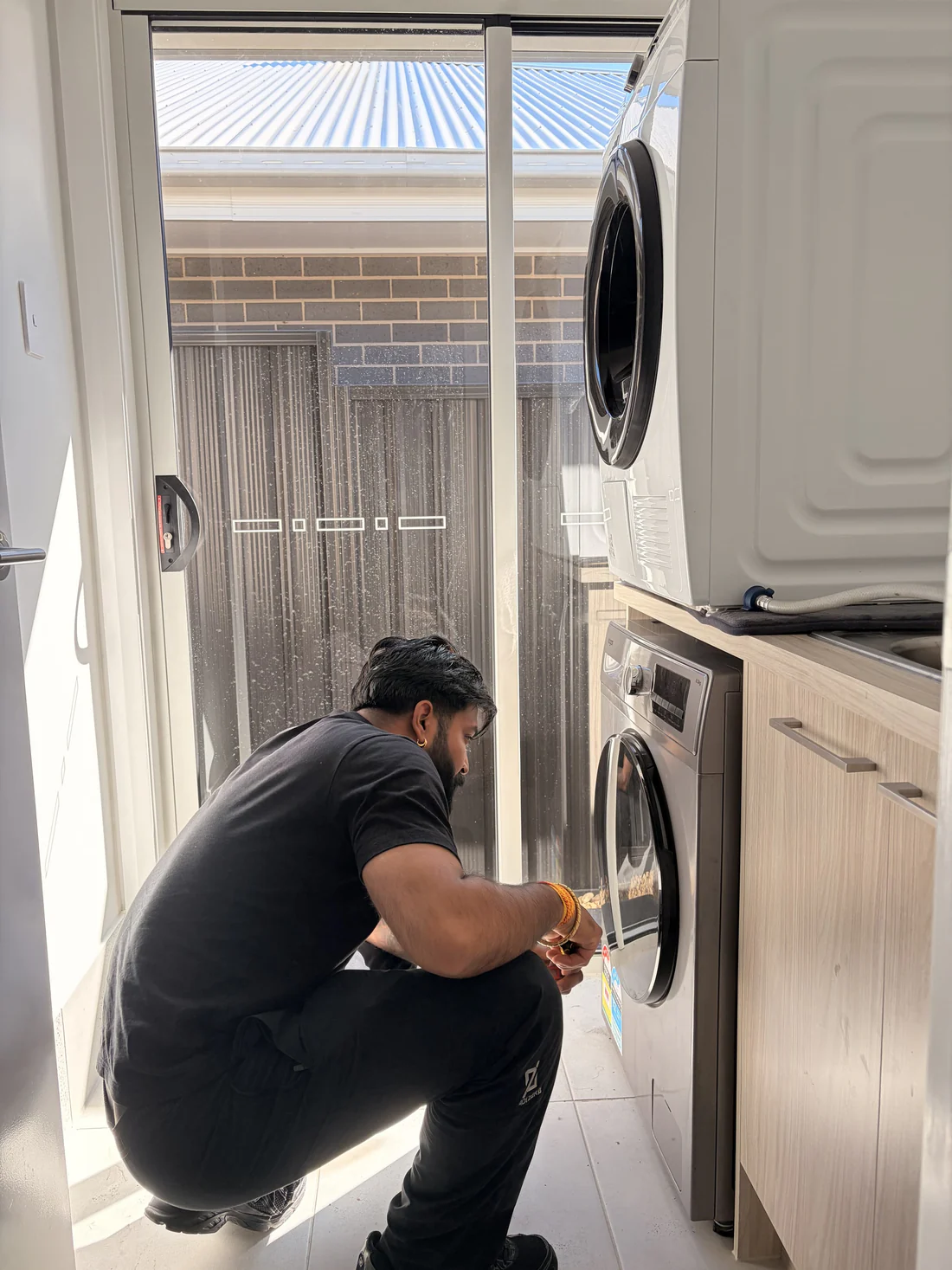 Reconnecting a washing machine in the laundry at the new address