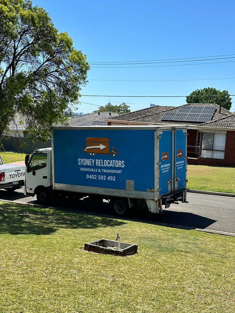 The Sydney Relocators truck parked kerbside on a quiet suburban street